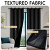 A set of textured black fabric curtains shown in front and back views, hanging over a window.