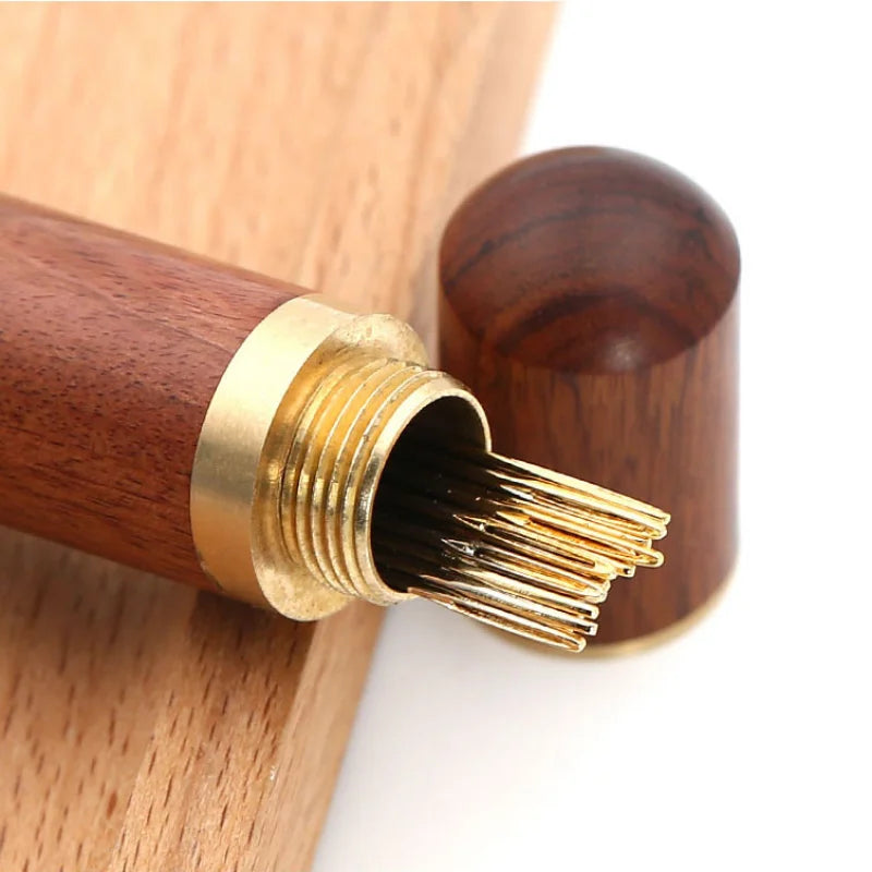 A set of stainless steel blind sewing needles with wooden handles and gold accents.