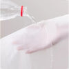 A clear bottle is pouring liquid onto a white fabric, demonstrating the function of a transparent zippered clothes storage ba