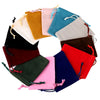 A circular arrangement of velvet drawstring jewelry gift bags in various colors including yellow, pink, blue, green, and red.