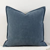 A solid blue gray chenille throw pillow with a pointed shape.