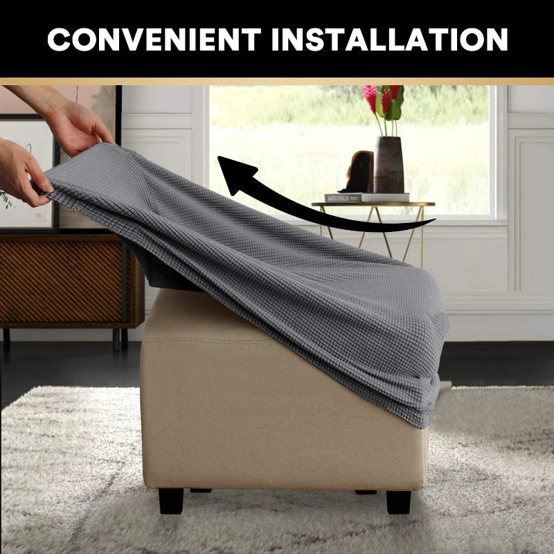 A hand is installing a gray slipcover onto a beige square footrest ottoman.