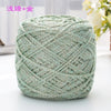 A ball of metallic silver-green silk yarn used for crocheting and knitting.