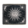 A dark throw blanket featuring a celestial design with stylized suns and moons.