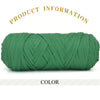 A spool of thick, dark green polyester blended yarn coiled tightly for crafting.
