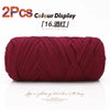 Two crimson elastic yarn skeins displayed on a white background for crafting