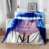 A blue and white retro printed flannel throw blanket featuring a portrait of a person.