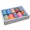 A box filled with ten rolls of brightly colored rainbow sewing thread in various shades and textures.