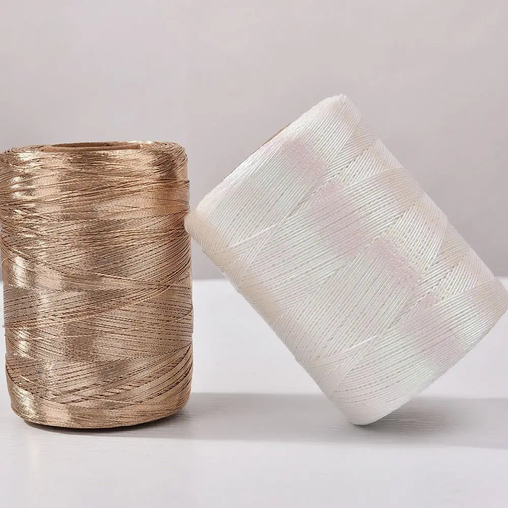 Spool of glitter metallic yarn in gold and white shades