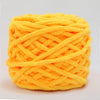 A ball of bright orange chenille knitting yarn with an intricate woven texture.
