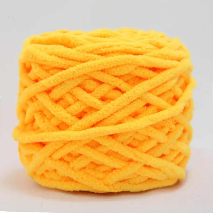A ball of bright orange chenille knitting yarn with an intricate woven texture.
