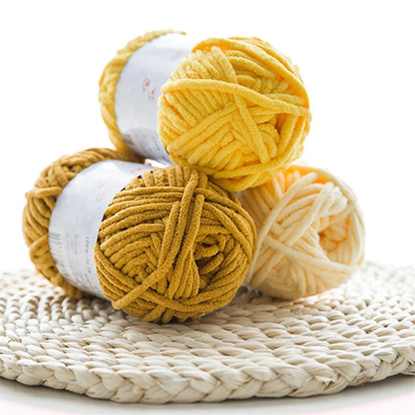 A ball of thick, golden yellow velvet yarn used for knitting and crochet projects.