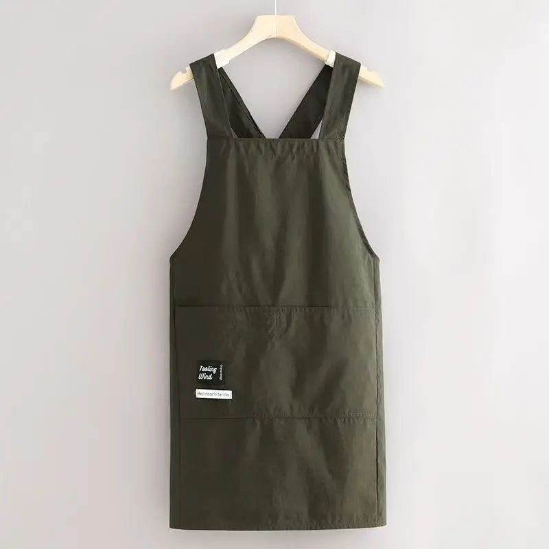 A dark olive green water-resistant kitchen apron with adjustable straps hanging on a wooden hanger.