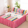 Set of three fitted bed sheets featuring colorful stripes and a pink lace trim on a bed.