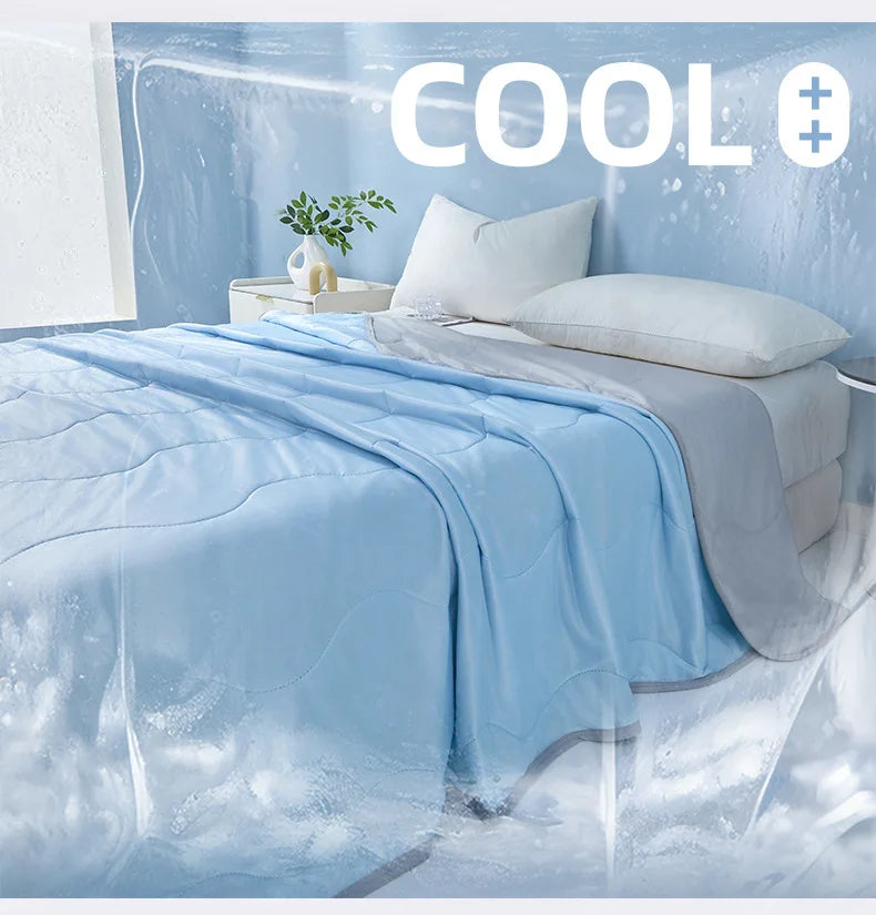 A light blue quilted blanket draped over a bed, with ice or water effects in the background.
