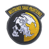 A round black military patch featuring a white foxhound skull silhouette against a yellow circle and gold lettering.