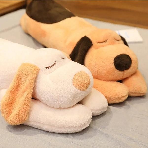 A large, light orange and white plush dog pillow doll lying on a gray surface.