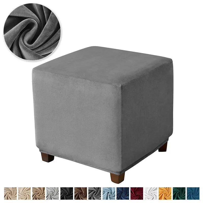 A square gray velvet ottoman slipcover shown next to a rolled fabric sample.