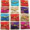 A collection of multi-color silk brocade jewelry pouches in various floral patterns and colors.