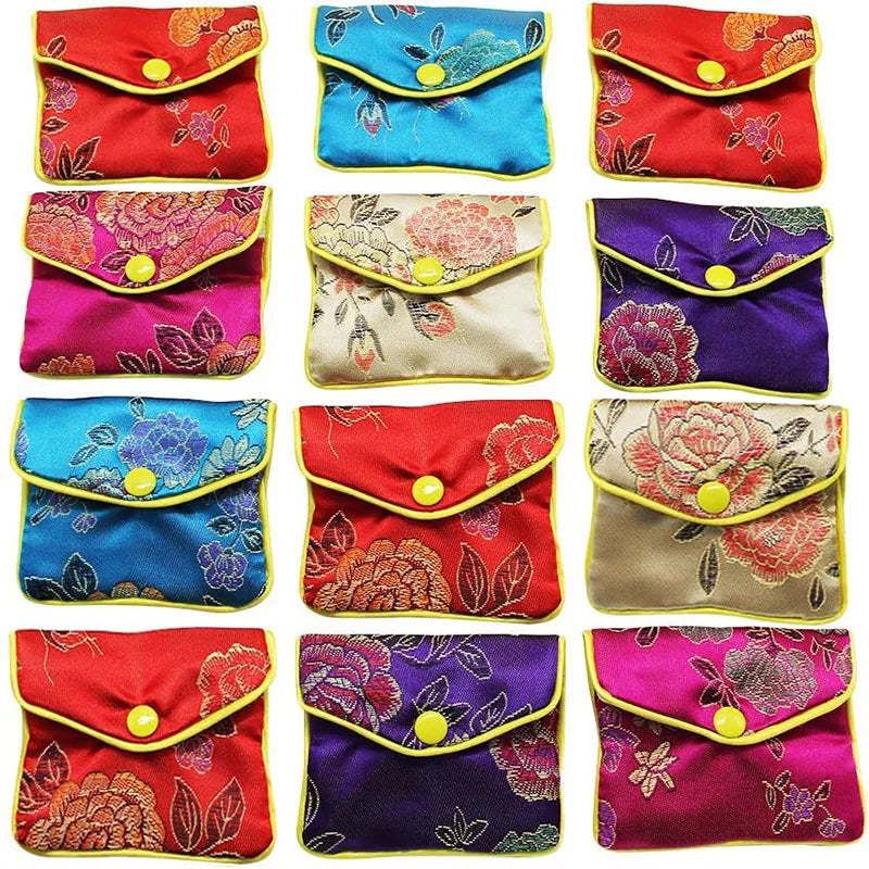 A collection of multi-color silk brocade jewelry pouches in various floral patterns and colors.