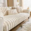 A cream-colored plush rabbit sofa cushion with textured fabric is displayed indoors.