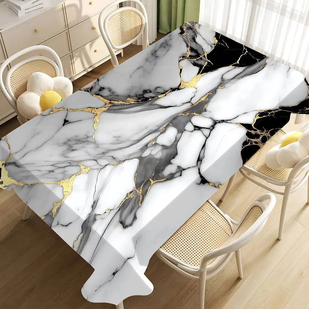 A white marble pattern table cloth with black veining and gold accents displayed on a dining table.