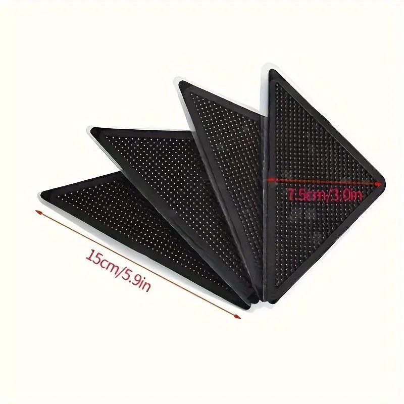 A set of black non-slip carpet grippers for floors shown in an angled view.