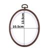 Round wooden embroidery hoop with a clear plastic cover and measurement markings