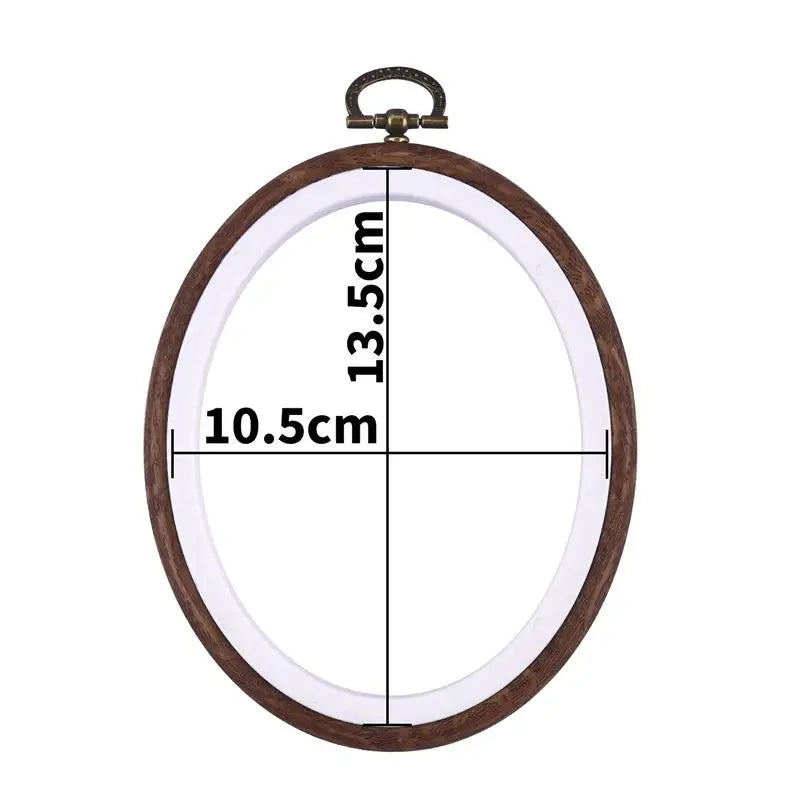 Round wooden embroidery hoop with a clear plastic cover and measurement markings