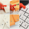 Close-up view of orange and white fabric being fastened using red snap fastener crimping pliers and a crochet hook.