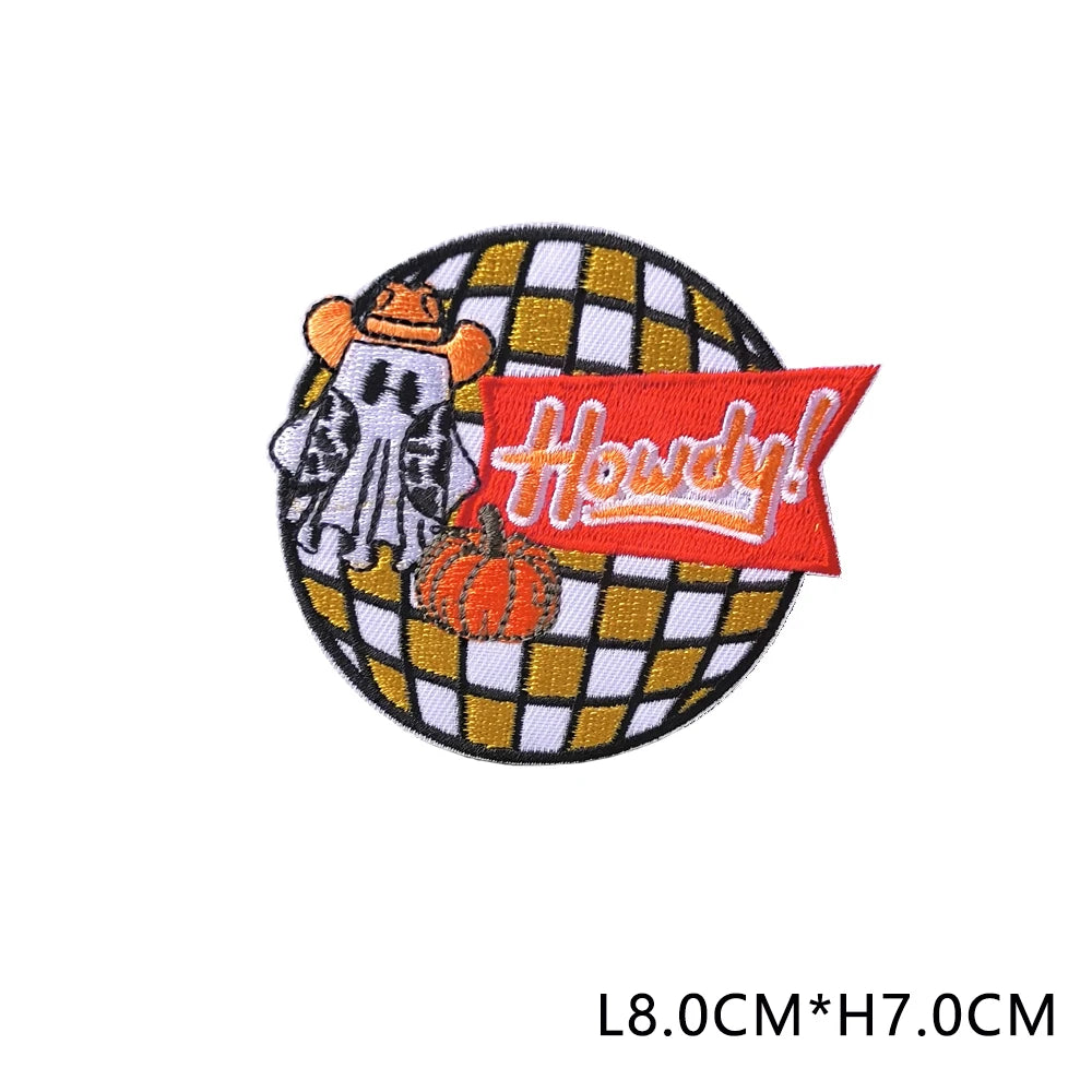 Iron-on patch featuring a stylized white cat face and an orange pumpkin design on a yellow background.
