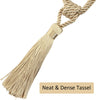 A beige braided rope with a tassel used as an elegant curtain tieback.