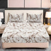 A beige bed with a marble print fitted sheet set and pillows, featuring white and brown veining.