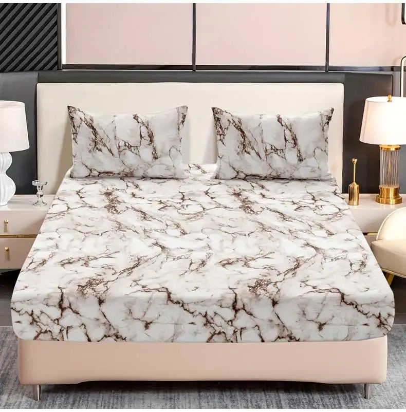 A beige bed with a marble print fitted sheet set and pillows, featuring white and brown veining.