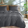 A gray luxury bamboo duvet cover set displayed on a bed with natural light streaming through.