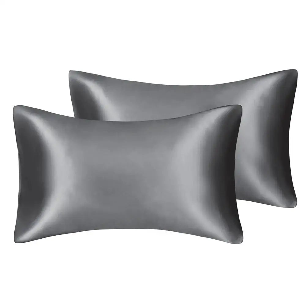 Two smooth, dark gray silky satin pillow covers displayed side by side.
