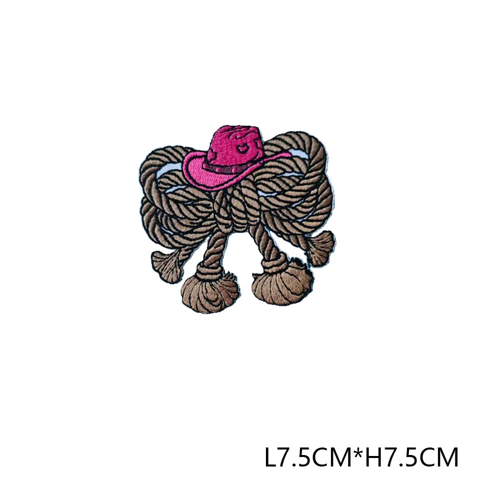 A pink embroidered letter patch featuring a straw hat woven into the design.