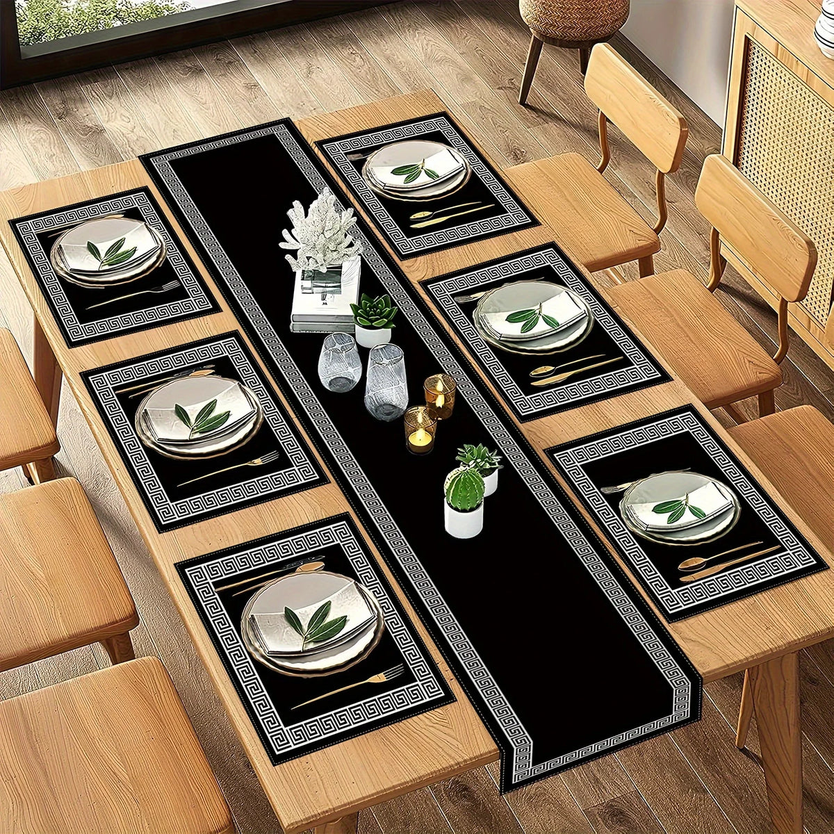 A set of luxury geometric placemats and table runners featuring silver-rimmed plates on a black background.