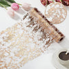 Roll of gold and silver sequin glitter table runner material next to pink tulips and a small cup