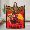A person holds up a black flannel throw blanket featuring a graphic of a cowboy gunfighter against a fiery background.