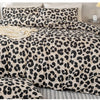 A leopard print duvet cover set featuring black and beige spots on a bed.