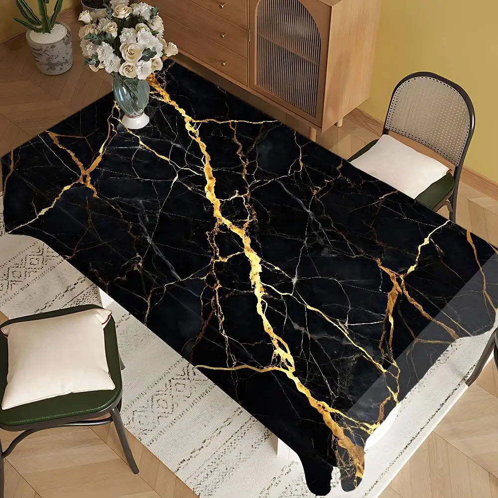 Black marble table cloth with gold veining placed on a wooden table.