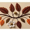 A decorative floral branch featuring various autumn-toned leaves and berries used as a table runner design.