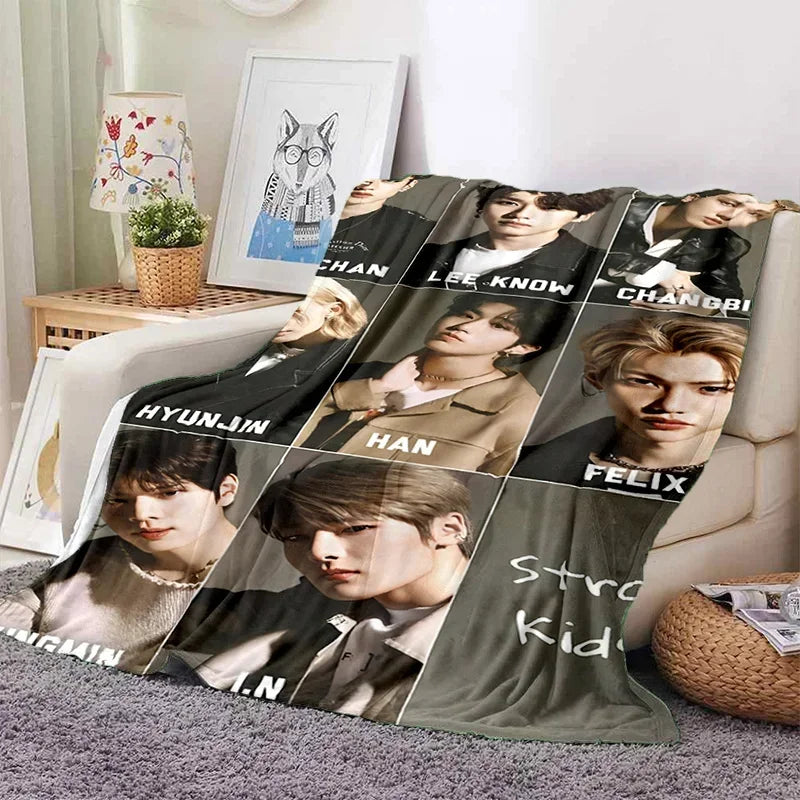 A fleece throw blanket featuring 3D printed images of Stray Kids members.