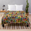 A colorful wool sheep blanket spread out on a floor, next to a white pillow and a wooden nightstand.