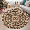 A round woven jute rug with geometric patterns in black and natural beige tones on a light wooden floor.