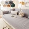A light gray anti-slip fabric sofa cushion cover with a chevron pattern and decorative round fabric accents.