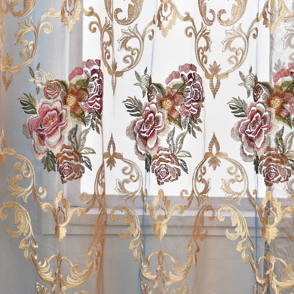 Sheer curtains featuring ornate gold floral embroidery and sheer fabric panels.