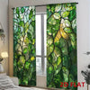 Two panels of green stained glass leaf light-filtering curtains hanging in a window.