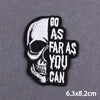 Black embroidered skull iron-on patch with text that reads Go as far as you can